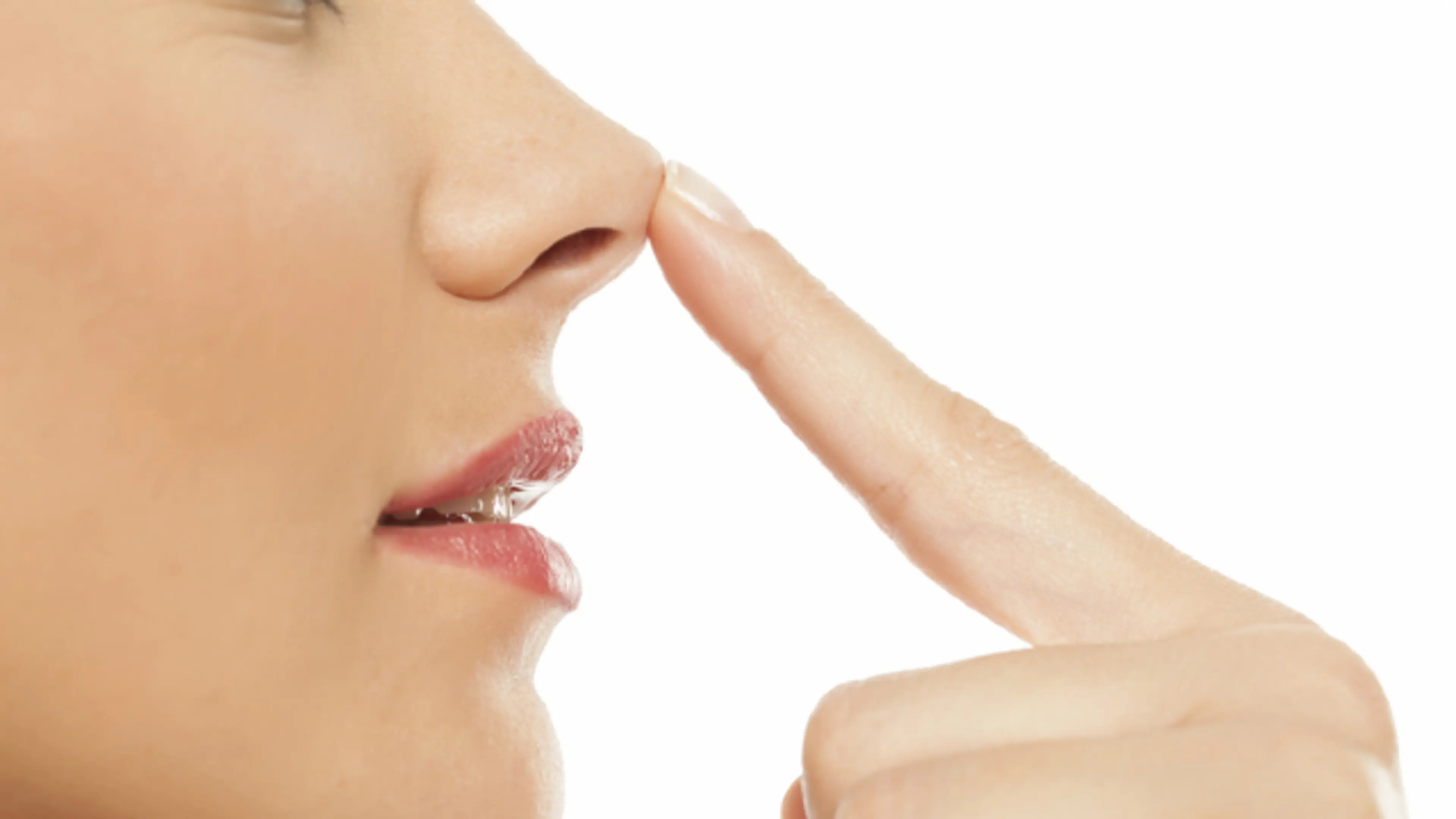 Woman touching nose tip in close up profile view